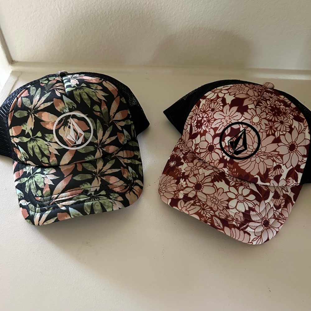 Pair of Volcom printed snap back hats